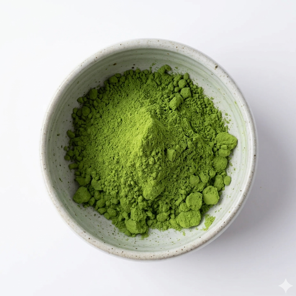Green matcha powder in a white bowl on a white background